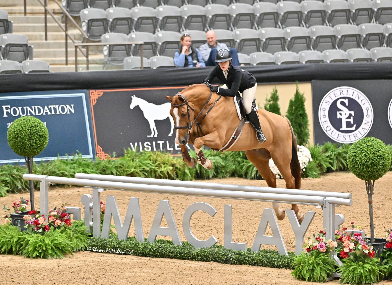 A rider clears the Maclay fence at a horse show